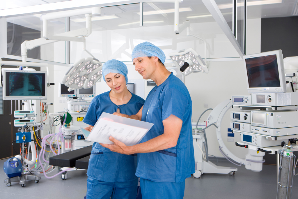 Cath Lab clinicians reviewing a patient report generated with SoftCath